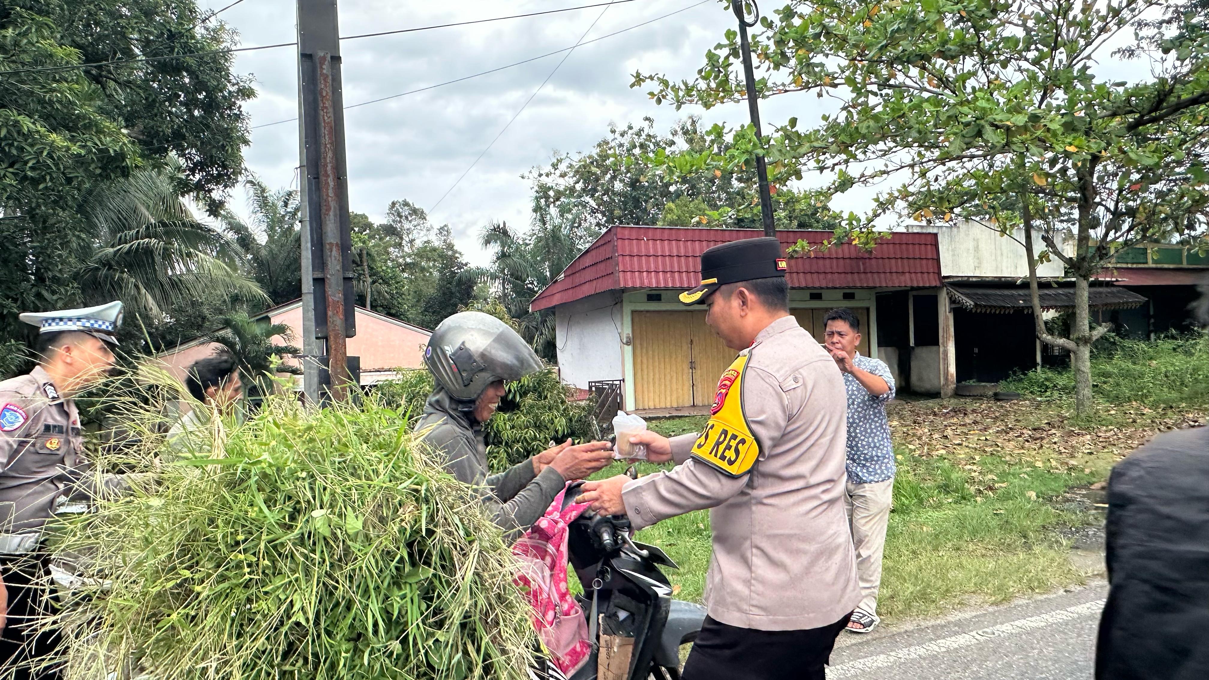 Kapolres Dharmasraya Bagikan Takjil kepada Pengendara dan Tukang Cabut Rumput
